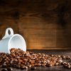 white-cup-surrounded-by-coffee-beans_1112-443